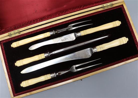 A cased ivory handled silver collared carving set